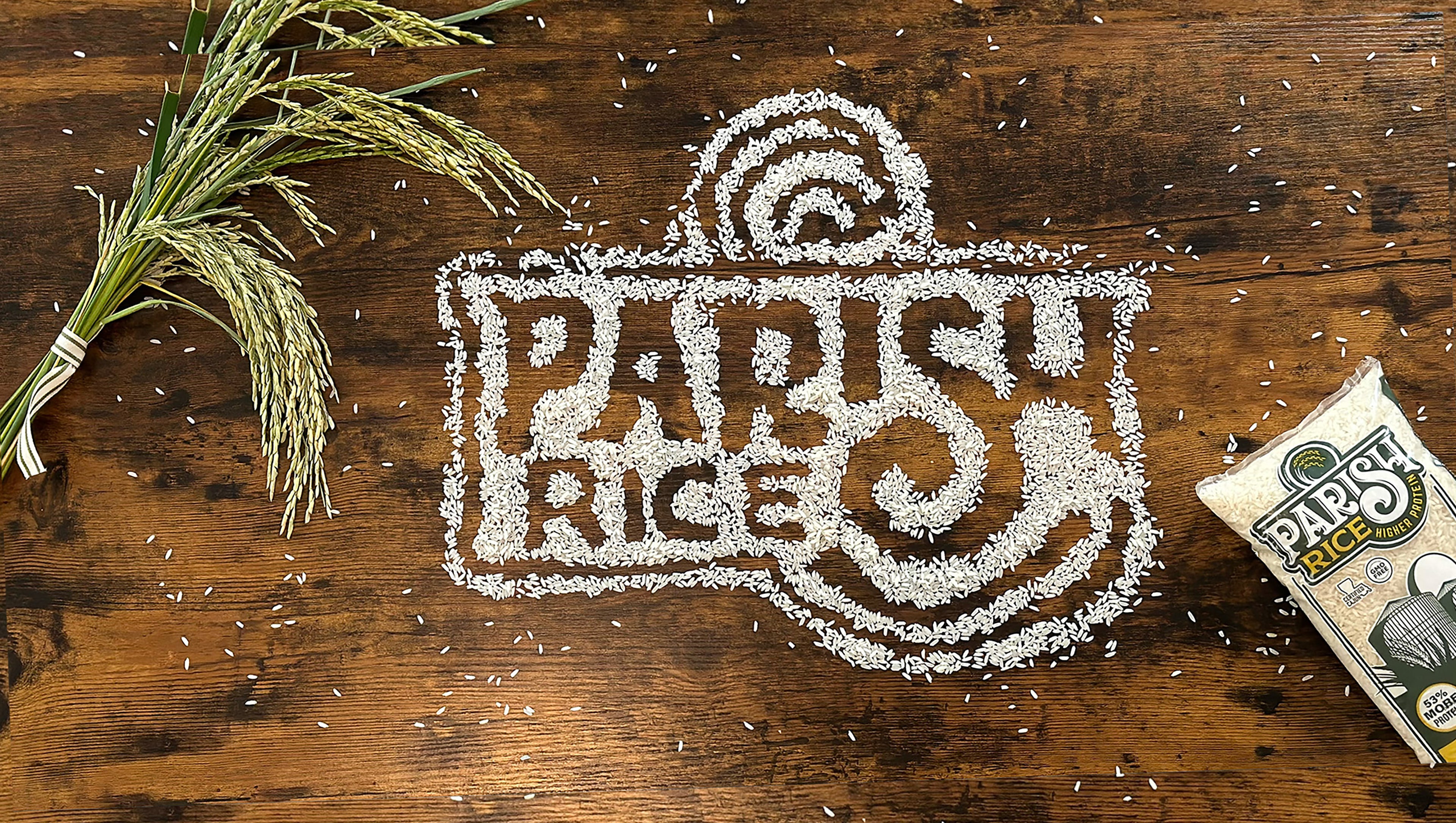 Healthy Parish Rice grains arranged on a wooden table with rice bag